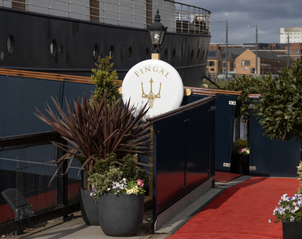 The brow on Fingal with planters of flowers next to the red carpet.