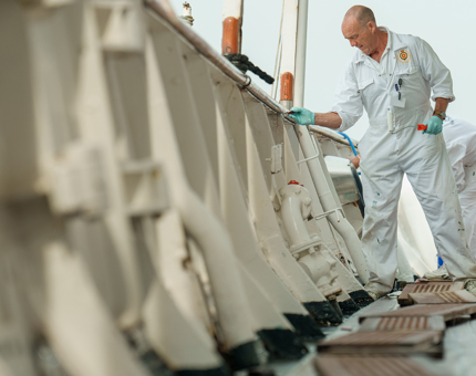 Two Yotties are painting on the Fo'c's'le Deck.