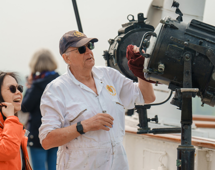 A visitor chatting with a Yottie as he demonstrates the navigation equipment.