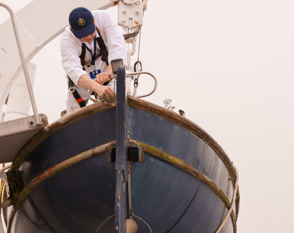 A Yottie working in a small boat.