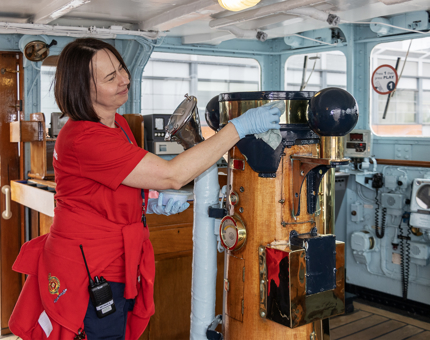 Polishing the brass in the Bridge of the ship