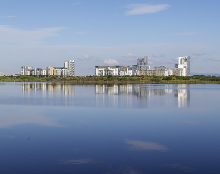 A view over the water with flats in the distance.
