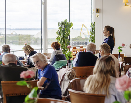 A busy Royal Deck Tearoom with many visitors sitting at tables.