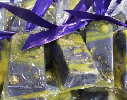 Bars of fudge tied with purple ribbon. 