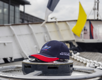 A navy and red Britannia baseball cap on the Fo'c's'le Deck.