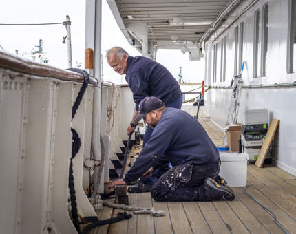 Two members of the Maintenance team are removing duckboards.