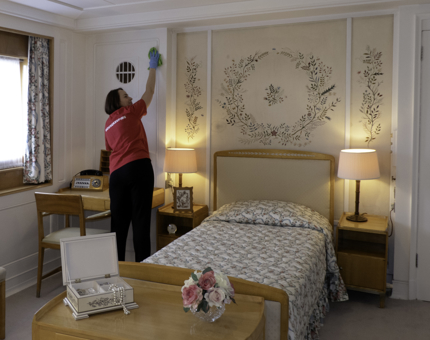 A woman is polishing inside Queen Elizabeth II's Bedroom.