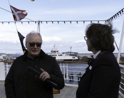 A Visitor Assistant chatting to a visitor on board Britannia. 