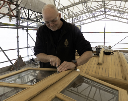 A member of the Maintenance team working on the Cupola of Bloodhound. 