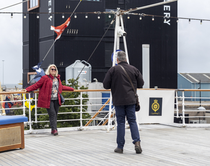 A couple take a photograph on the Verandah Deck at The Royal Yacht Britannia. 