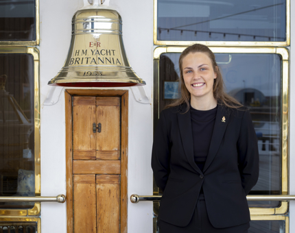 A woman is smiling by Britannia's Bell. 