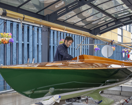 A Maintenance man is washing the keelboat, Coweslip. 