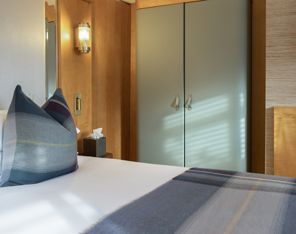 Inside the Skerryvore Suite at Fingal. There are tartan cushions and throws. 