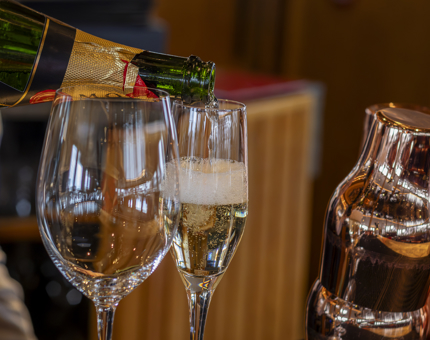 A glass of Champagne is poured. 