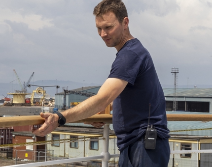 A man installing a wooden handrail on Fingal. 