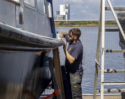 Ben sanding the fast motor launch.