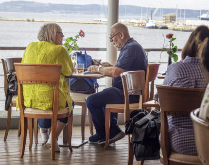 A couple enjoying drinks while sitting at a table in the Tearoom. 