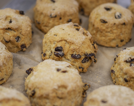 A tray of freshly bakes fruit scones. 