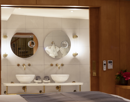 A bathroom with two sinks and two mirrors. 