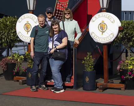 A groups of four people pose for a photo in front of the Royal Brow.