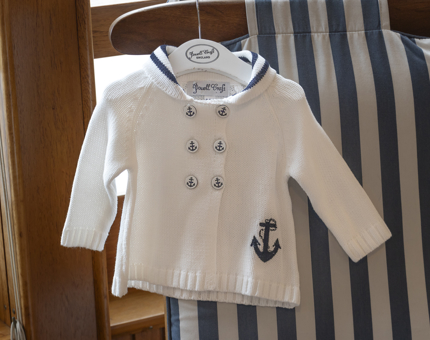A white and blue sailor-style children's top. 