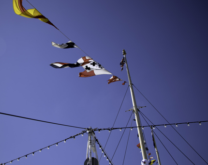 Blue skies and flags flying in the breeze. 