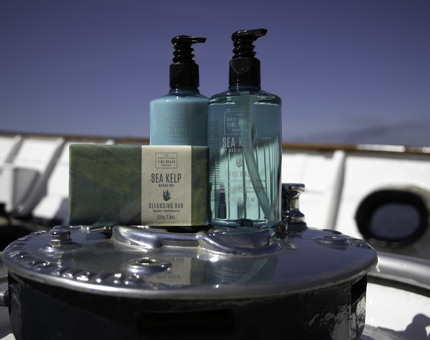 Bath and body products in blue bottles from Scottish Fine Soaps Company. 