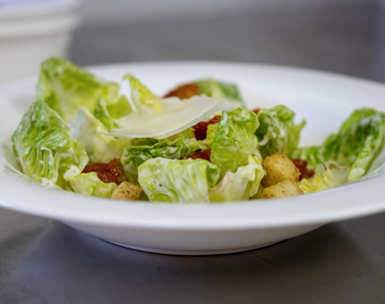 A bowl of Caesar salad.