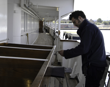 Maintenance team member screws parts of a refurbished set of steps.