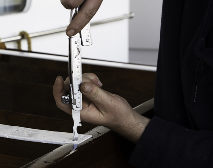 A close-up of a maintenance team member screwing part into the newly refurbished set of steps.
