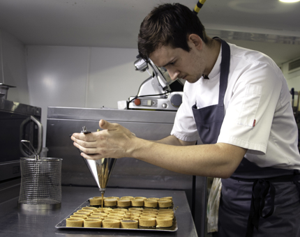 A Chef working on a dessert. 