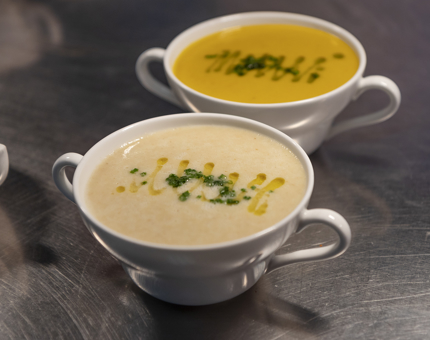 Two bowls of soup, one cullen skink, the other carrot. 