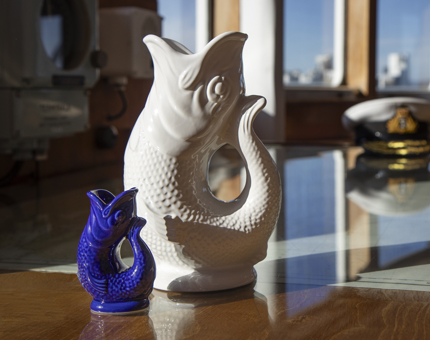 A large white and a small blue Gluggle jug. 