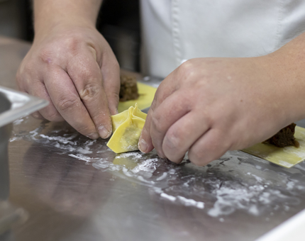 A close-up of duck wontons being made.