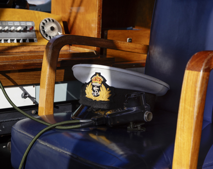 A Captain's hat sitting on the Captain's chair in the Bridge. 