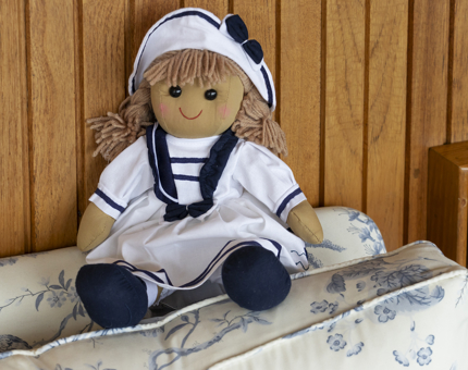 A rag doll dressed in a sailor's outfit. 