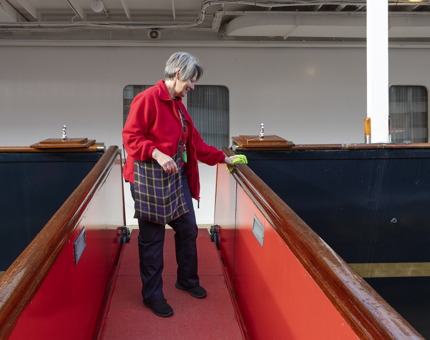 A member of the Housekeeping team polishing the railings of the Royal Brow. 