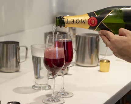 Two glasses with Champagne being poured into them.