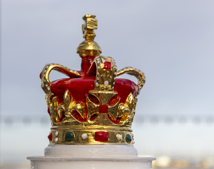 A decorative crown atop the compass binnacle. 