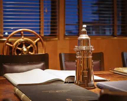Inside the Bridge at Fingal with the ship's wheel and table.