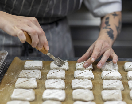 A Chef scoring dough. 