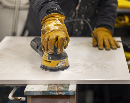 A closer look at a no entry barrier being sanded.