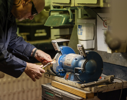 A wood chisel being sharpened.