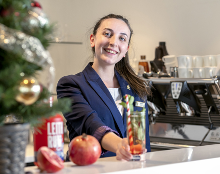 A member of the Tearoom team preparing a rum cocktail and the bar. 