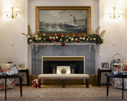An photo of the Drawing Room with Christmas decorations above the fireplace. 