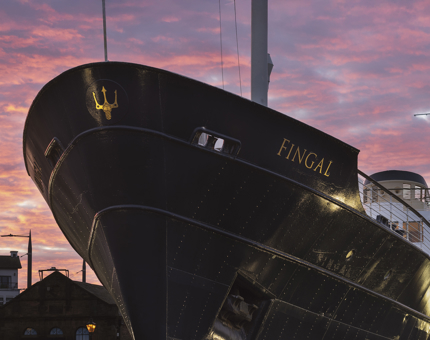 The bow of Fingal hotel with the sunset in the background.