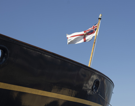 The bow of Britannia with a flag flying in the breeze. 
