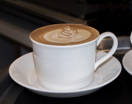 A coffee in a cup and saucer.