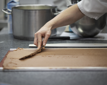 A Chef making chocolate sponge. 