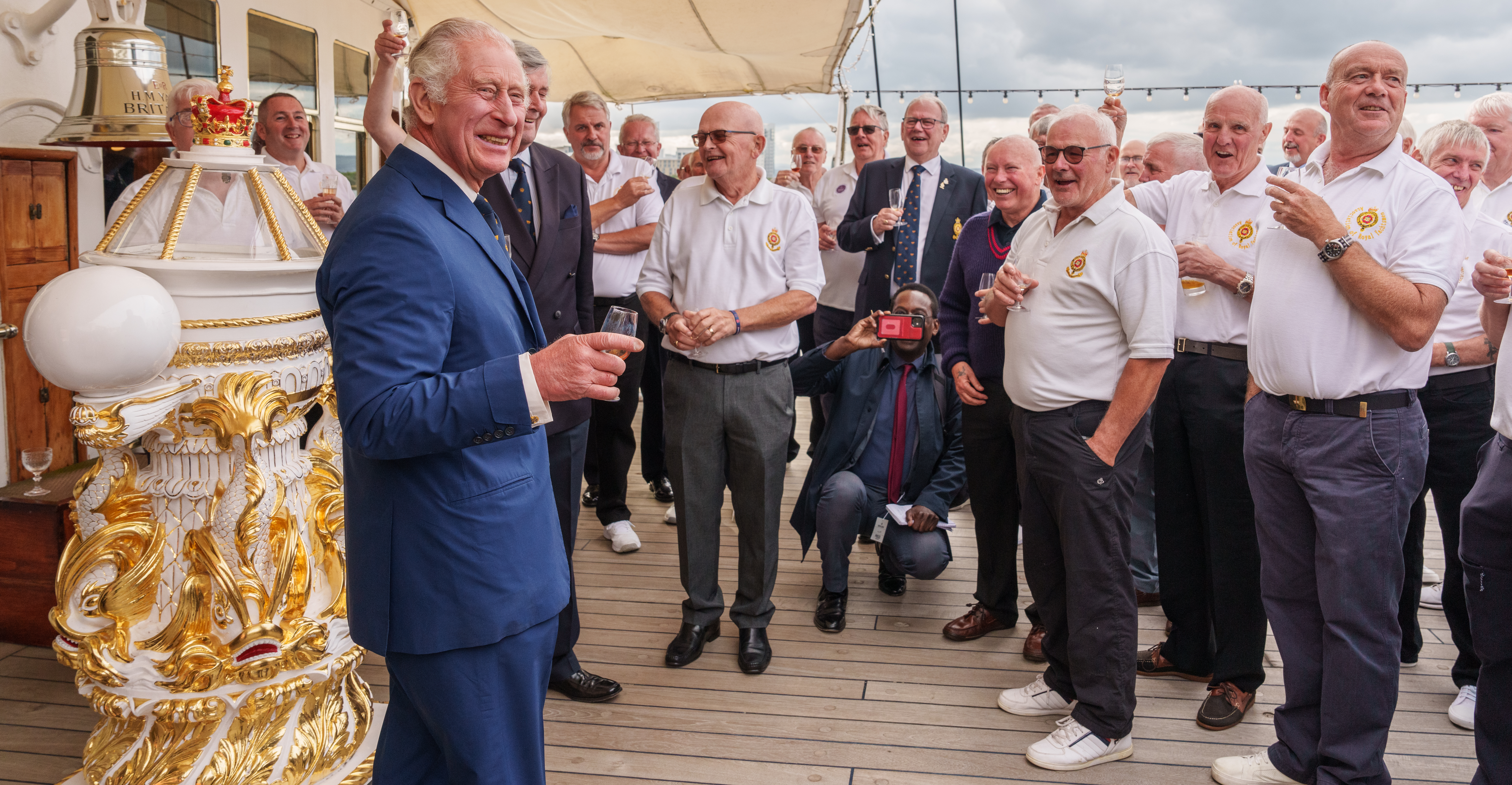 HM The King on the Verandah Deck raising a glass